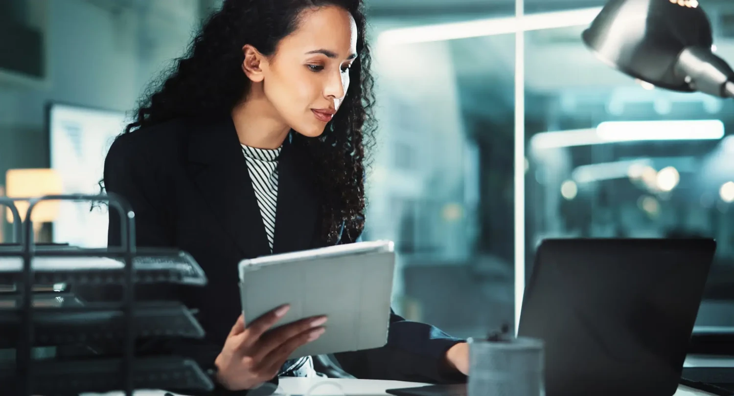 Woman with Notebook at Laptop
