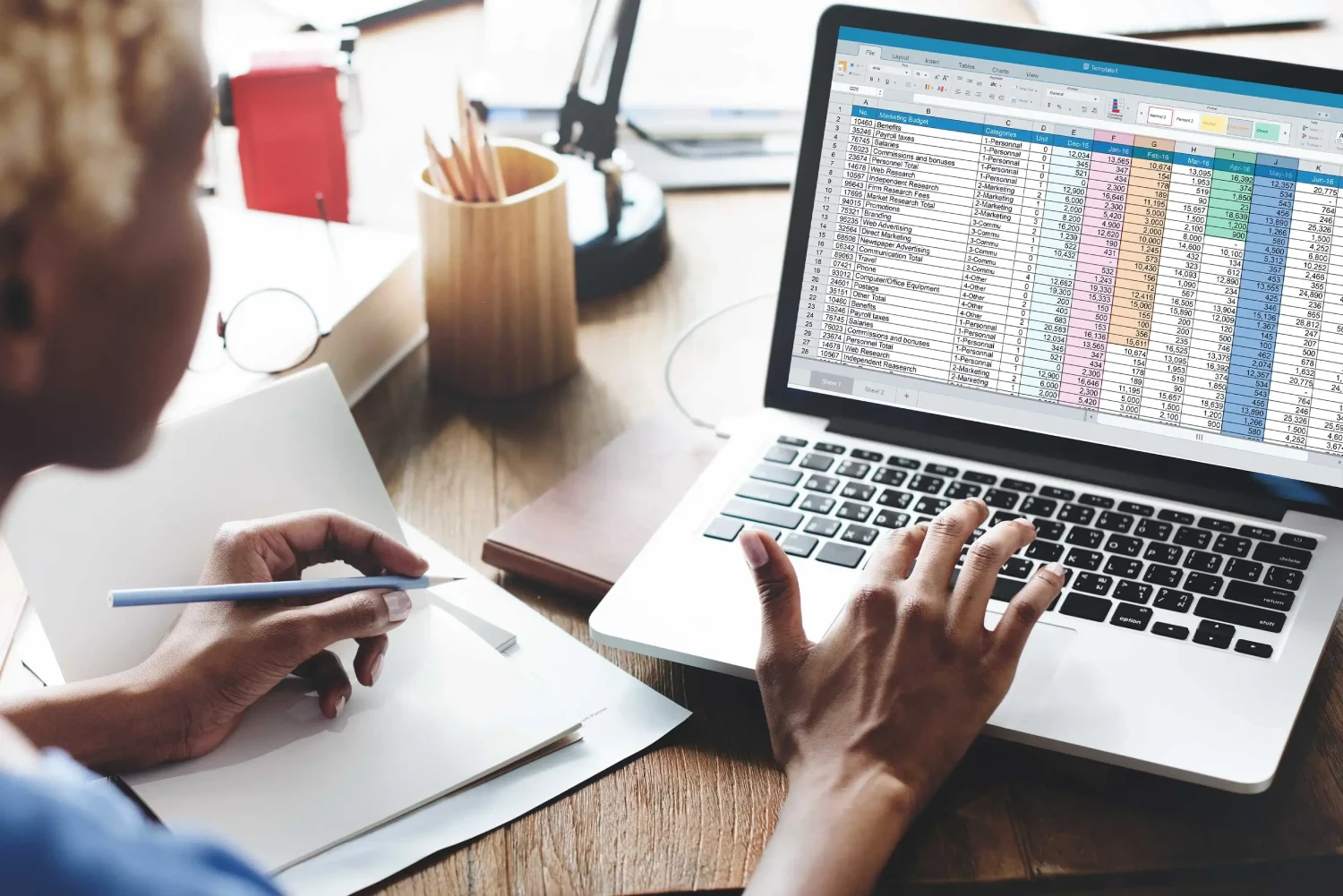 Woman Bookkeeping with Spreadsheet on Laptop