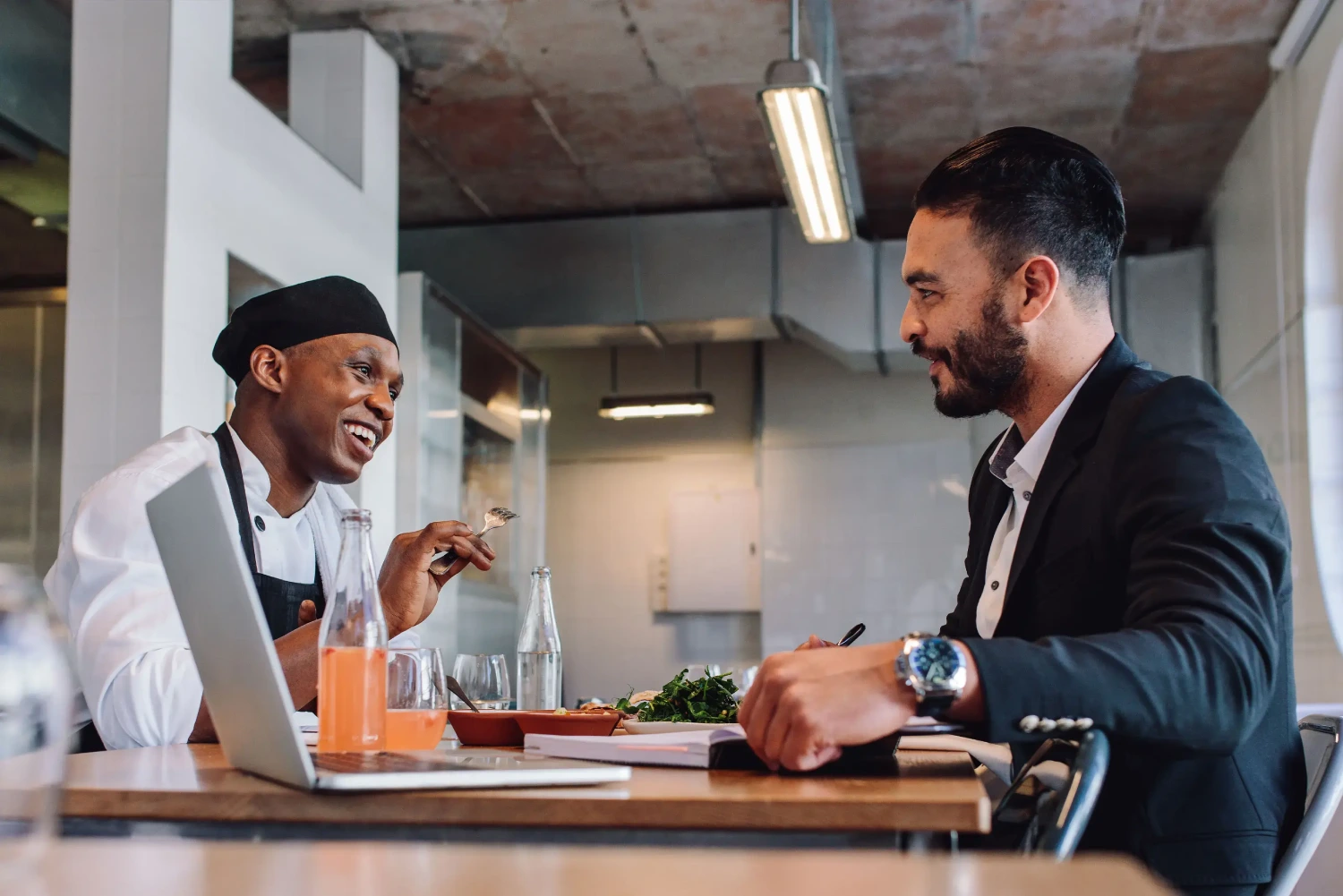 Man Handling Accounts in Restaurant with Worker
