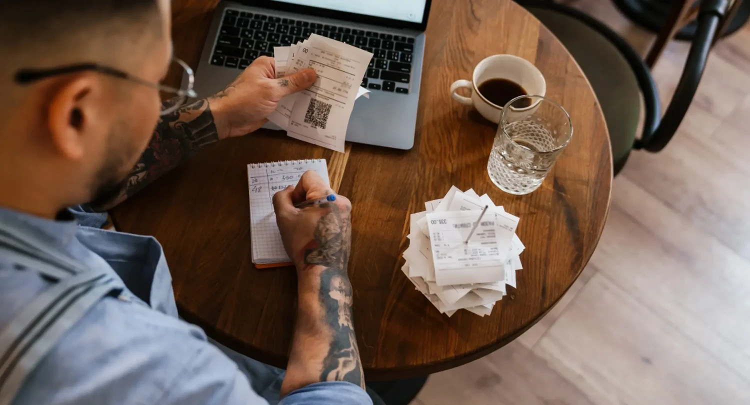 Man with Tattoos Handling Restaurant Accounting